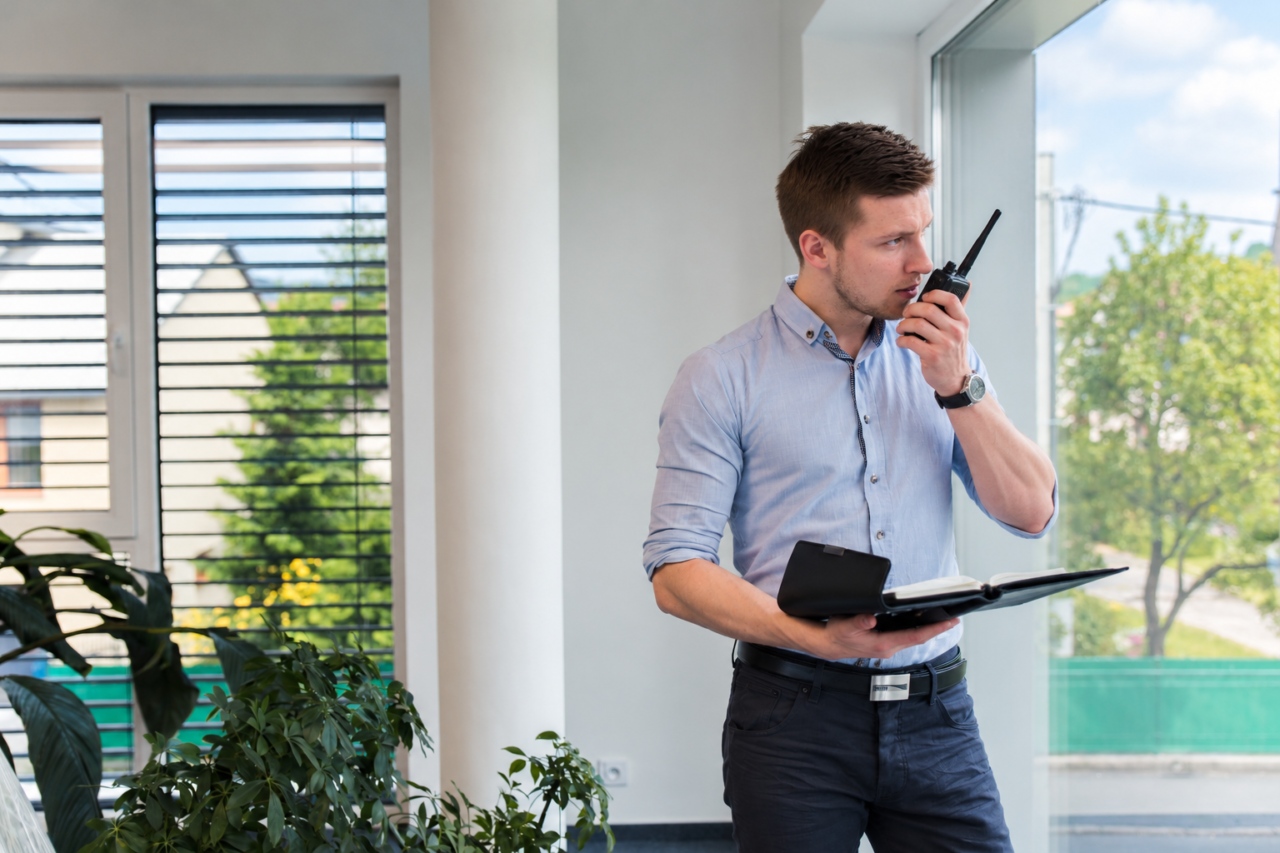 Facilities manager using facilities management two-way radios in an office building