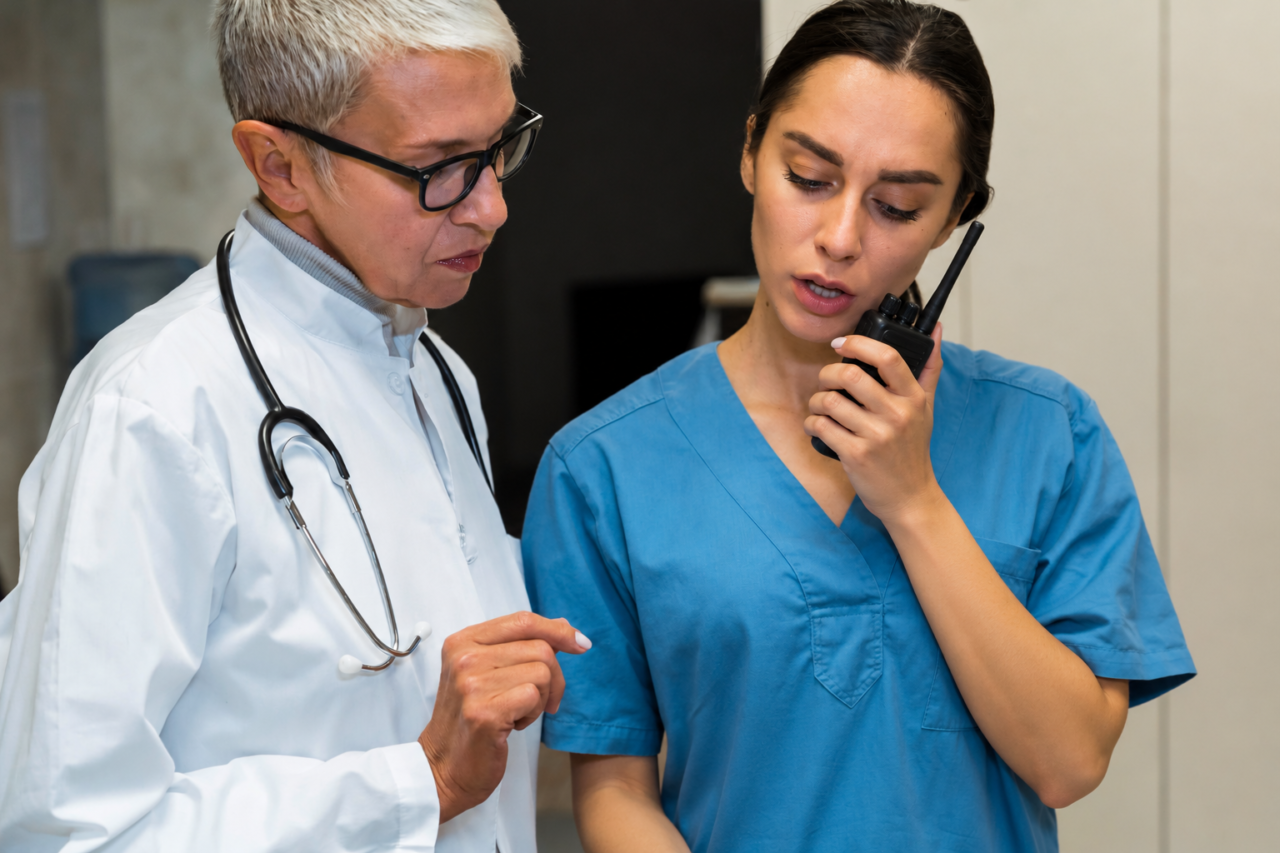 Nurse using hospital two-way radios while talking with a doctor
