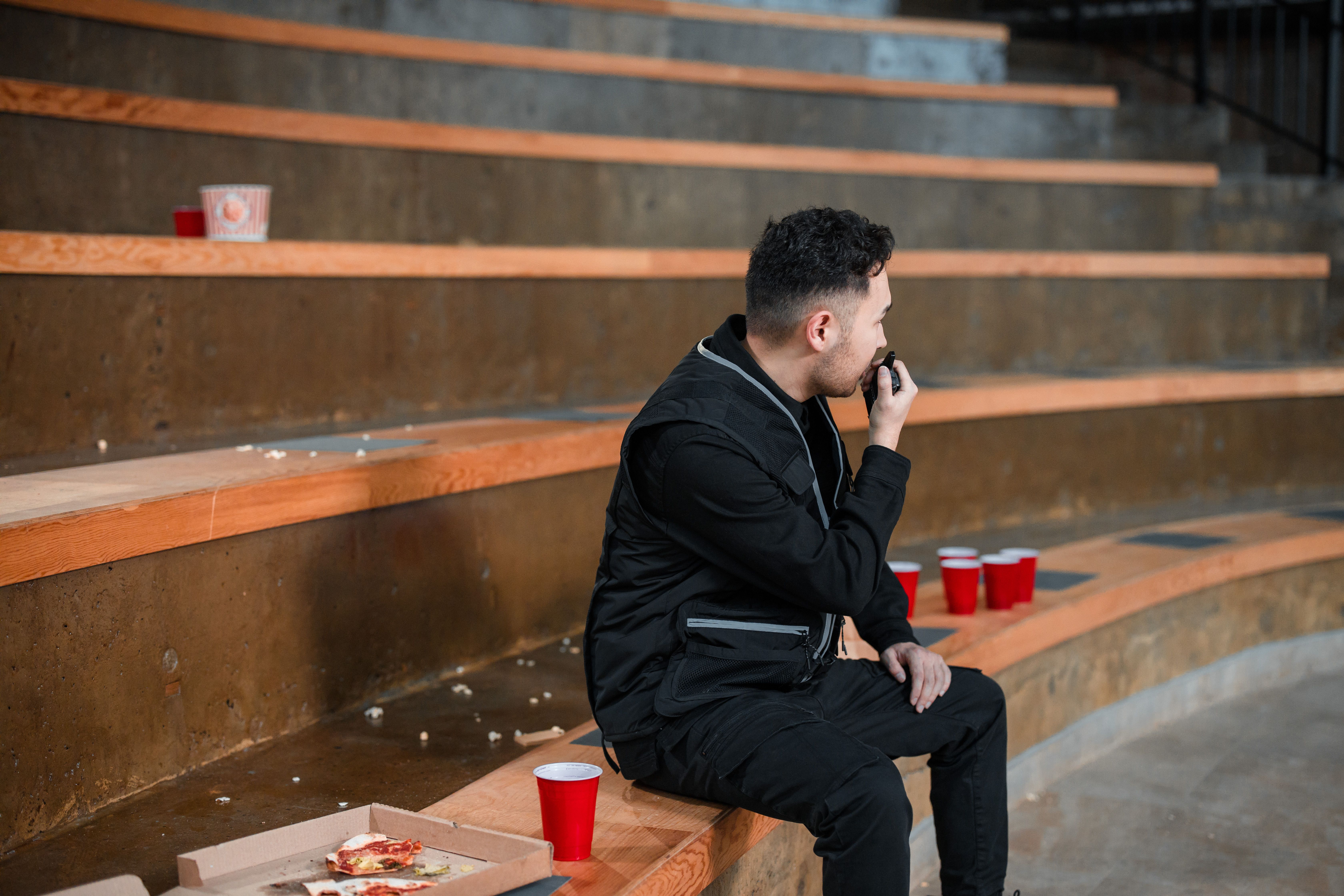 Security guard using a handheld radio at an event venue
