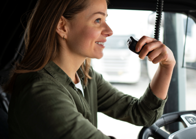 Truck driver using a vehicle-mounted two-way radio